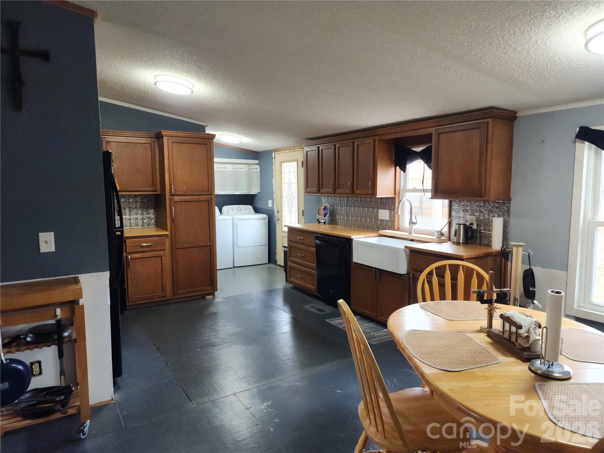 303 Johnson Dairy Road Mooresville, NC 28115 - Photo 17 of 36 a kitchen with refrigerator and cabinets