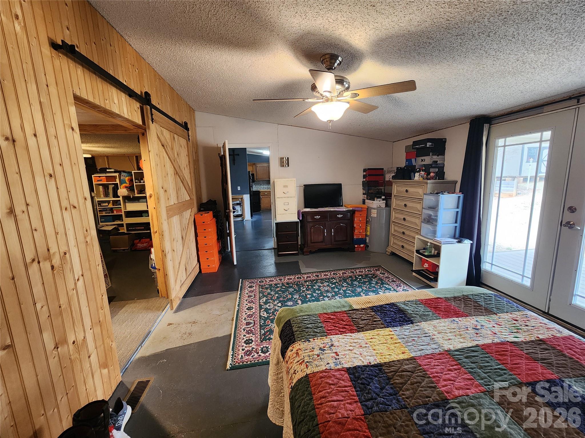 303 Johnson Dairy Road Mooresville, NC 28115 - Photo 20 of 36 a bedroom with a bed dresser and a flat tv screen