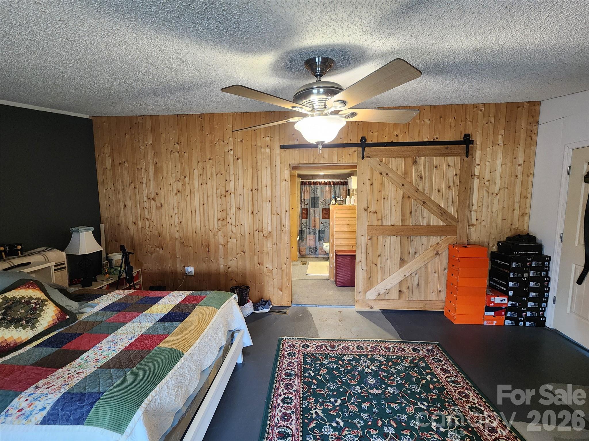 303 Johnson Dairy Road Mooresville, NC 28115 - Photo 22 of 36 a bedroom with a bed and a chandelier