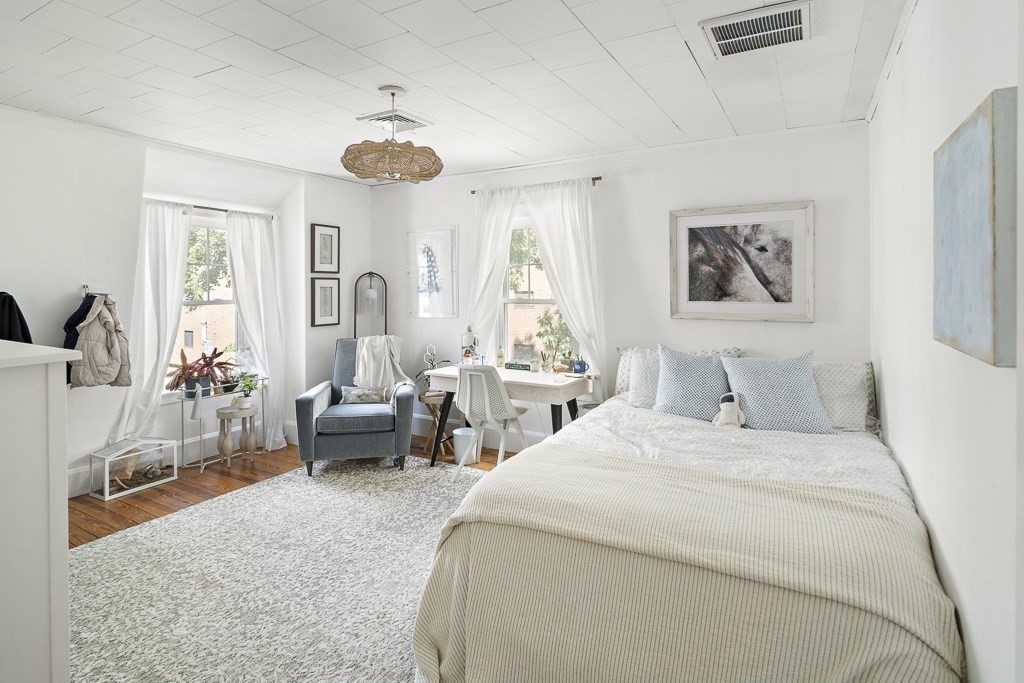 10 Spring Hill Terrace Somerville, MA 02143 - Photo 13 of 20 a bedroom with double bed and a large window