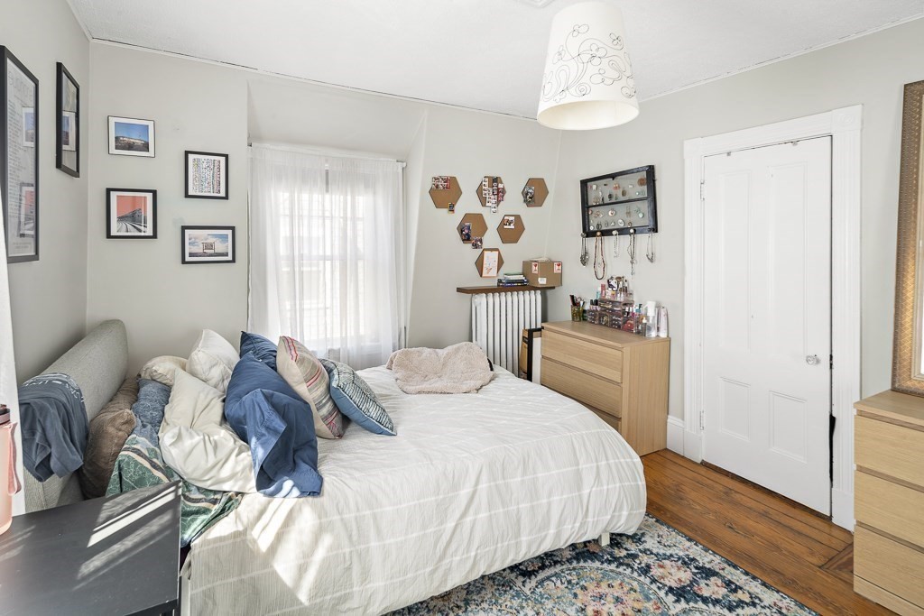 10 Spring Hill Terrace Somerville, MA 02143 - Photo 15 of 20 a bedroom with a bed and a window