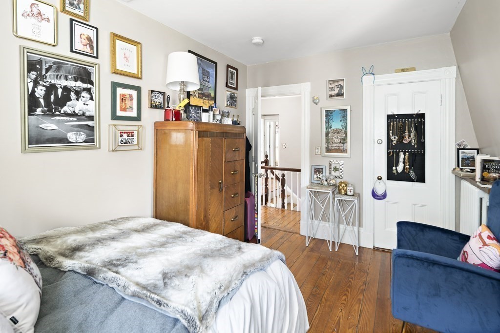 10 Spring Hill Terrace Somerville, MA 02143 - Photo 18 of 20 a bedroom with a bed furniture and a flat screen tv