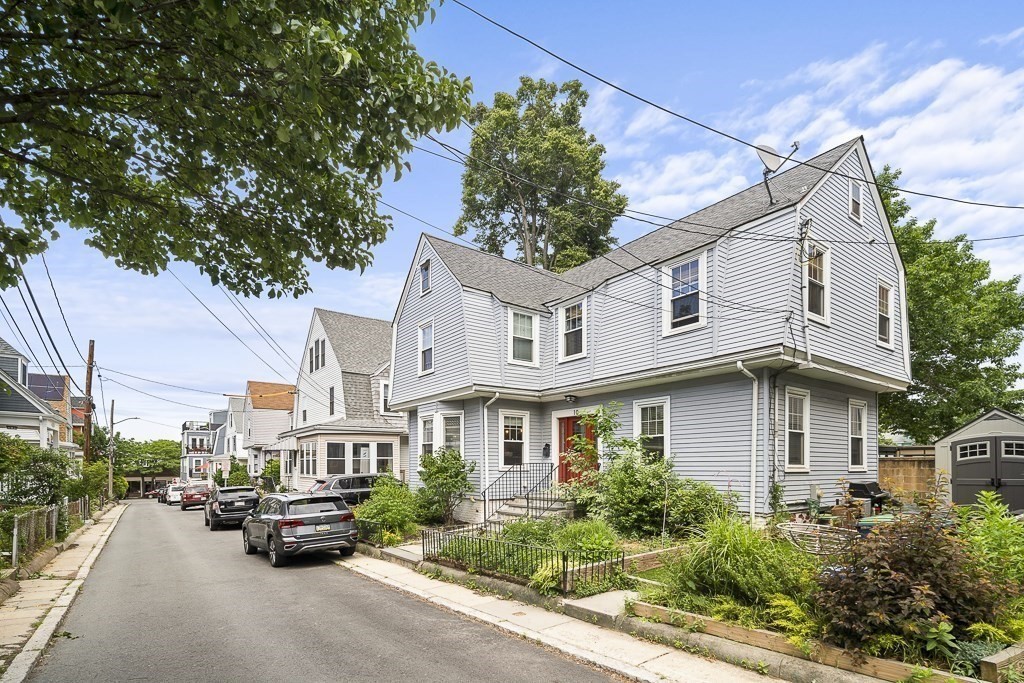 10 Spring Hill Terrace Somerville, MA 02143 - Photo 20 of 20 a view of a white house next to a road and plants
