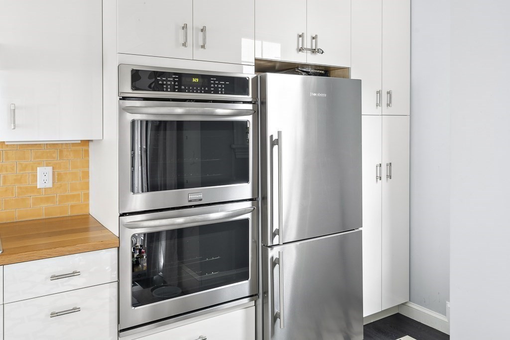 10 Spring Hill Terrace Somerville, MA 02143 - Photo 5 of 20 a kitchen with refrigerator a stove and cabinets