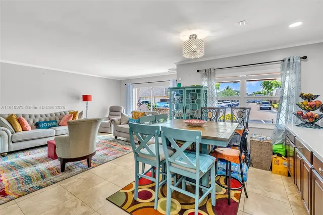 a living room with furniture a rug and a chandelier