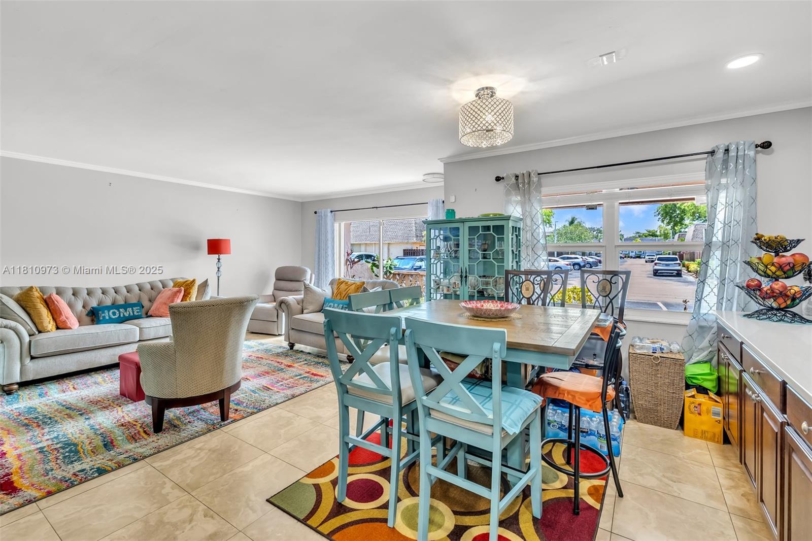 2316 Southwest 81st Way, Unit 8 North Lauderdale, FL 33068 - Photo 12 of 33 a living room with furniture a rug and a chandelier