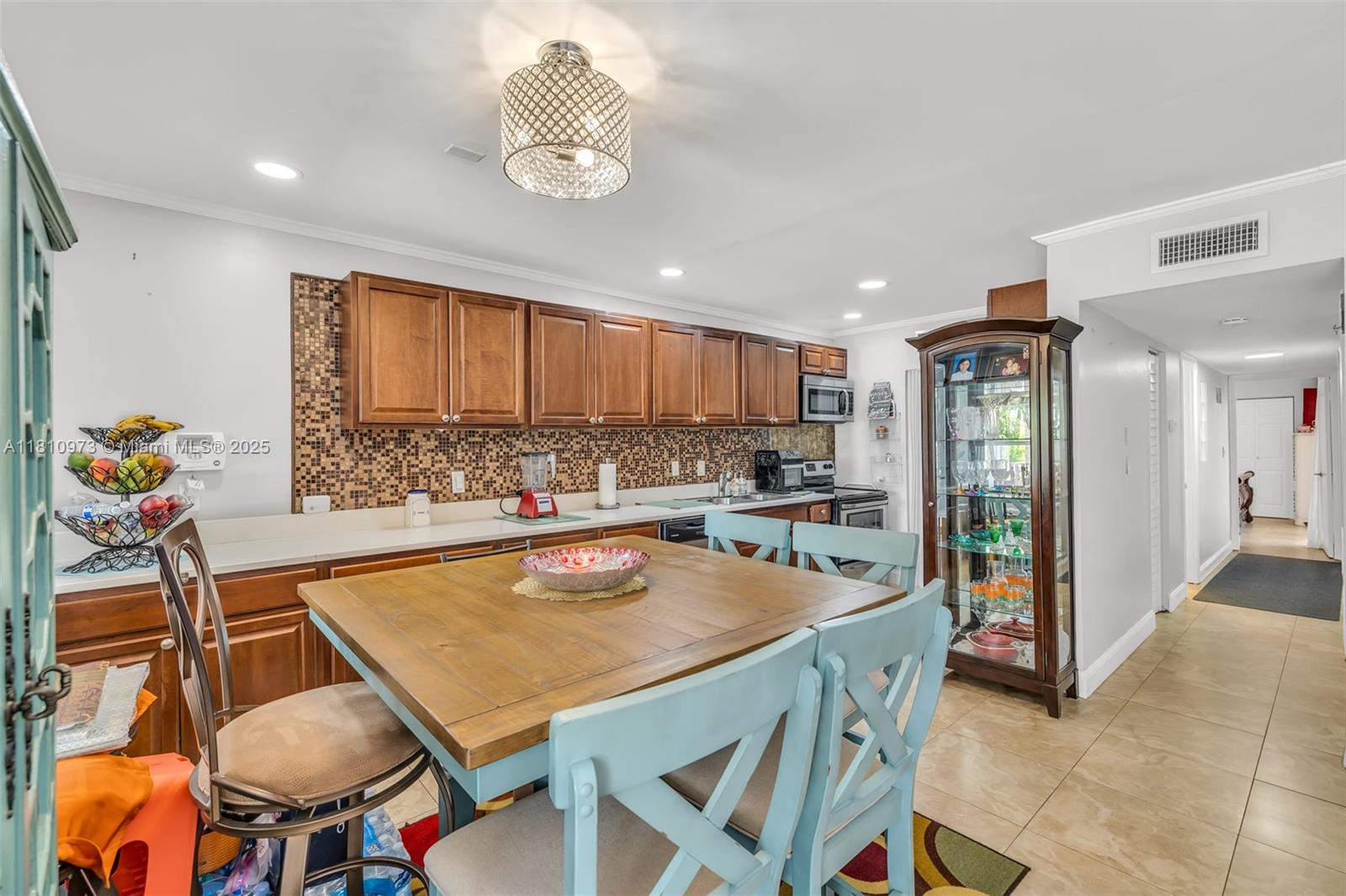2316 Southwest 81st Way, Unit 8 North Lauderdale, FL 33068 - Photo 13 of 33 a kitchen with a table chairs sink and refrigerator