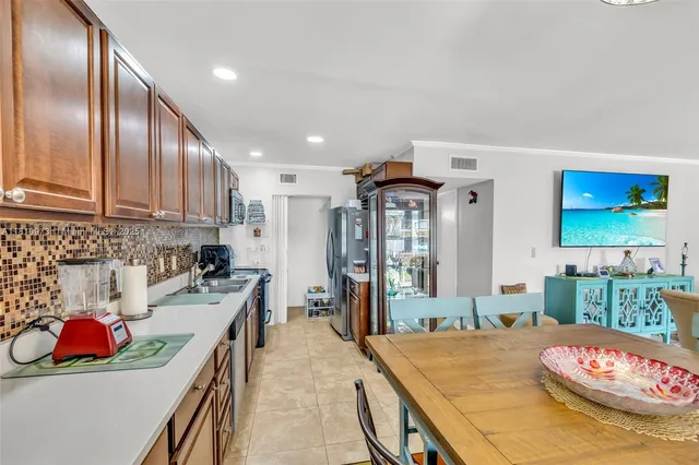 a kitchen with stainless steel appliances granite countertop a stove a sink and dishwasher