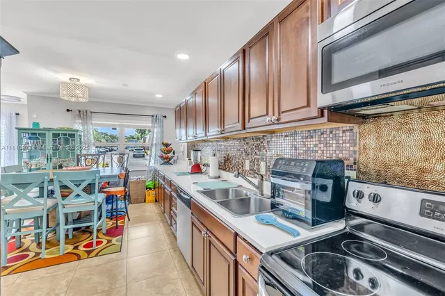a kitchen with stainless steel appliances granite countertop a stove and a sink