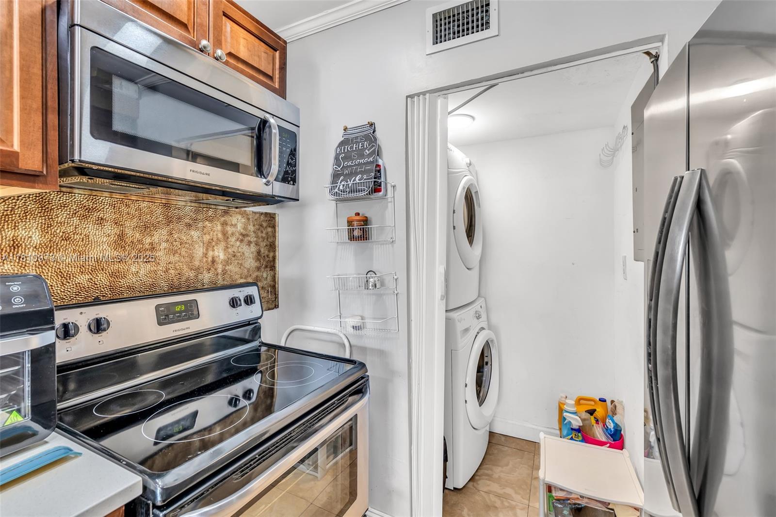 2316 Southwest 81st Way, Unit 8 North Lauderdale, FL 33068 - Photo 17 of 33 a kitchen with stainless steel appliances granite countertop a refrigerator and a stove top oven