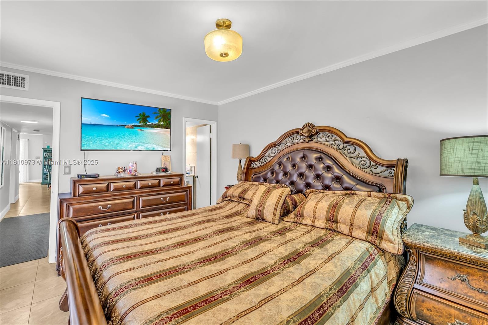 2316 Southwest 81st Way, Unit 8 North Lauderdale, FL 33068 - Photo 20 of 33 a bedroom with a bed and a flat screen tv