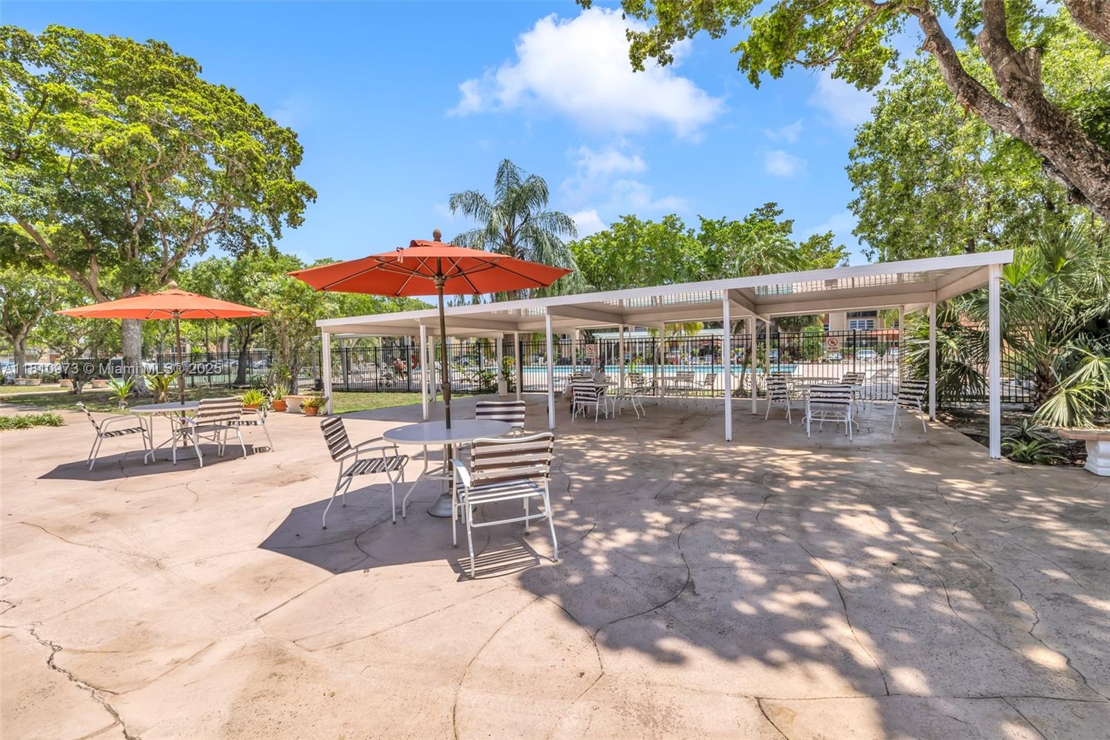 2316 Southwest 81st Way, Unit 8 North Lauderdale, FL 33068 - Photo 25 of 33 a view of a patio with a table and chairs under an umbrella