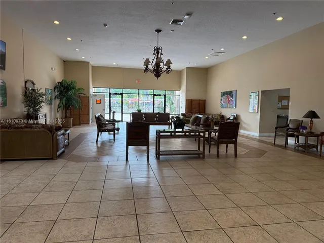 a living room with furniture a dining table and a potted plant