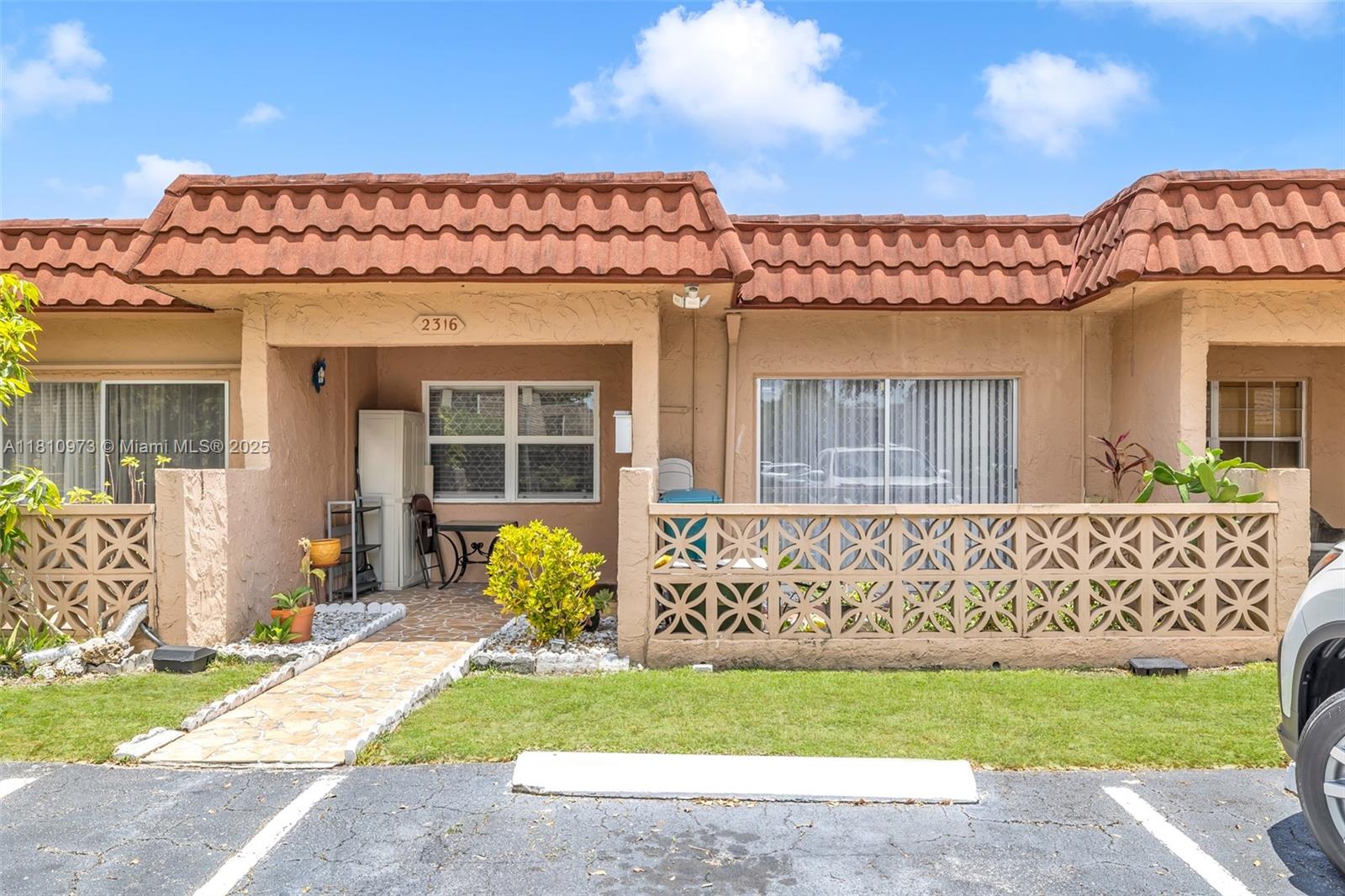 2316 Southwest 81st Way, Unit 8 North Lauderdale, FL 33068 - Photo 3 of 33 a front view of a house with a garden