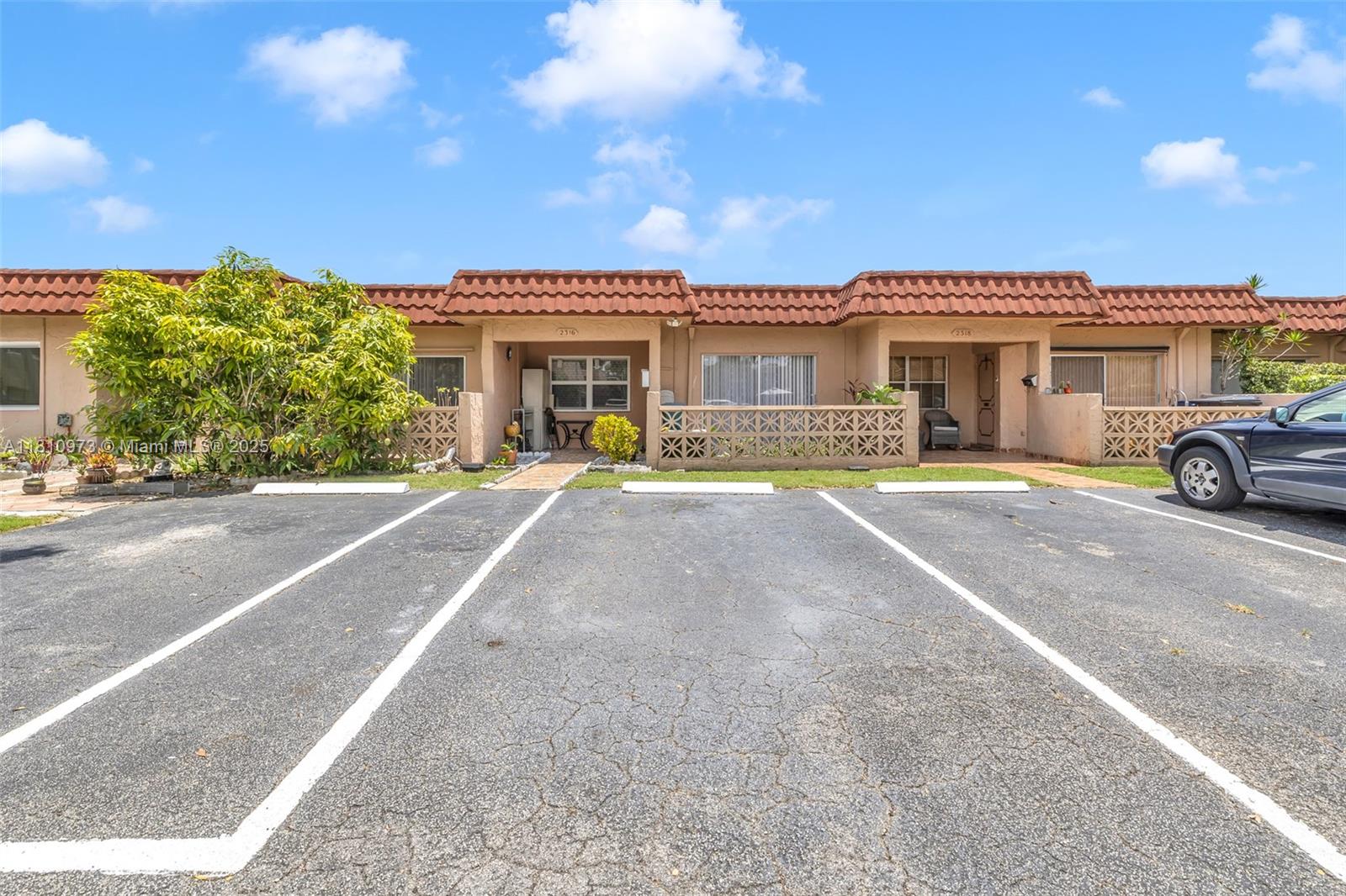 2316 Southwest 81st Way, Unit 8 North Lauderdale, FL 33068 - Photo 4 of 33 front view of a house with a patio