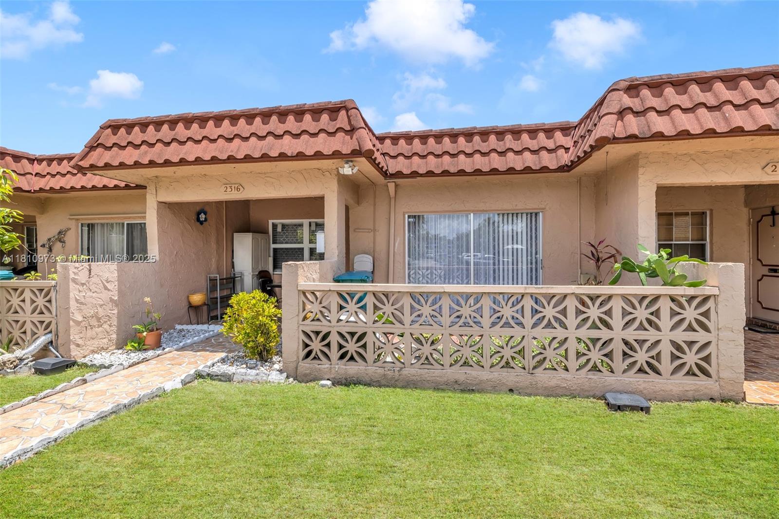 2316 Southwest 81st Way, Unit 8 North Lauderdale, FL 33068 - Photo 5 of 33 a front view of a house with a garden