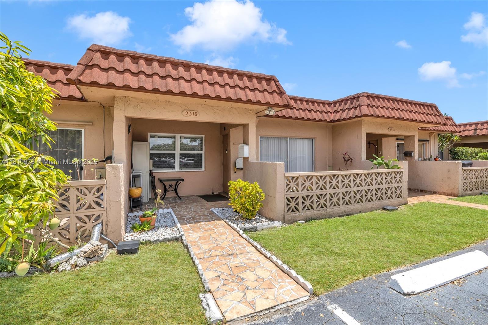 2316 Southwest 81st Way, Unit 8 North Lauderdale, FL 33068 - Photo 6 of 33 a view of a house with a yard and porch