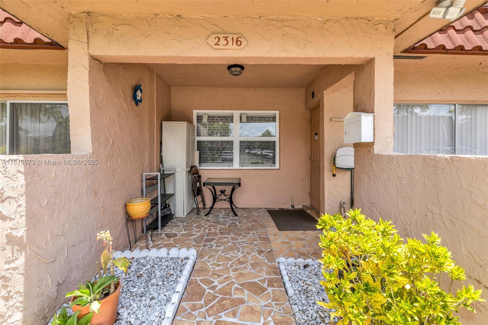 2316 Southwest 81st Way, Unit 8 North Lauderdale, FL 33068 - Photo 7 of 33 a front view of a house with chairs
