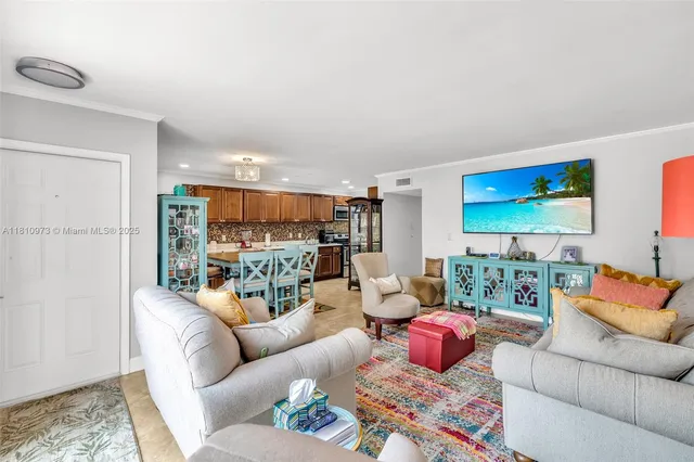 a living room with furniture kitchen view and a couch