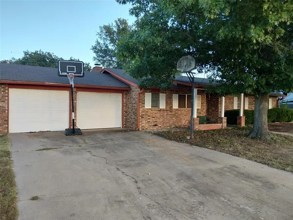 a view of a house with a yard and garage