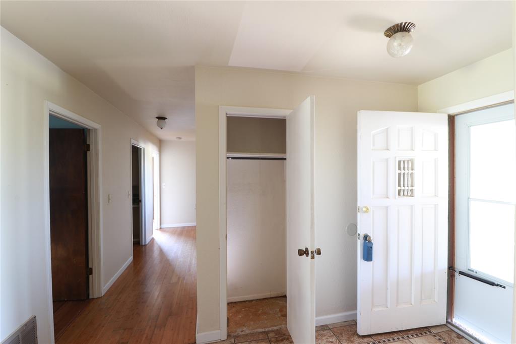 212 Palmer Drive Comanche, TX 76442 - Photo 13 of 40 a view of a hallway with wooden floor