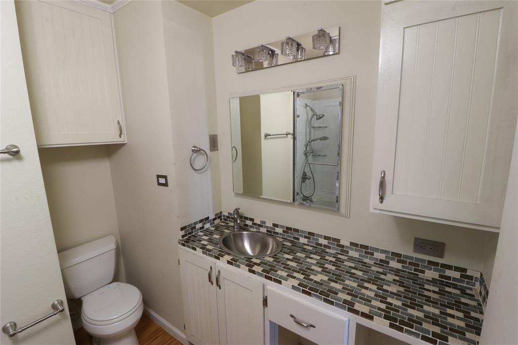 212 Palmer Drive Comanche, TX 76442 - Photo 20 of 40 a bathroom with a granite countertop sink toilet and shower