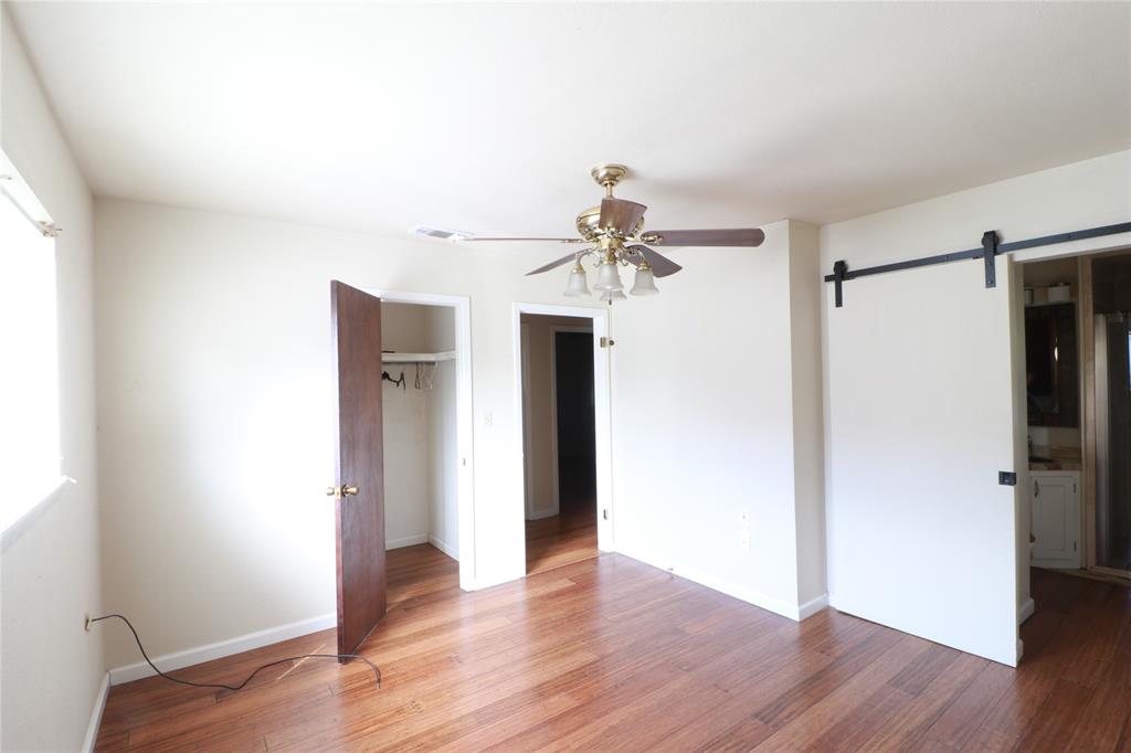 212 Palmer Drive Comanche, TX 76442 - Photo 23 of 40 wooden floor in an empty room