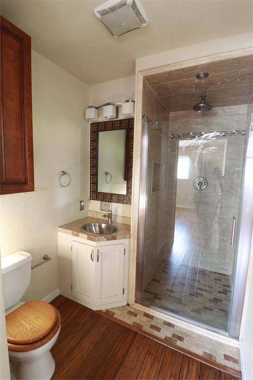 212 Palmer Drive Comanche, TX 76442 - Photo 25 of 40 a bathroom with a toilet a sink and shower