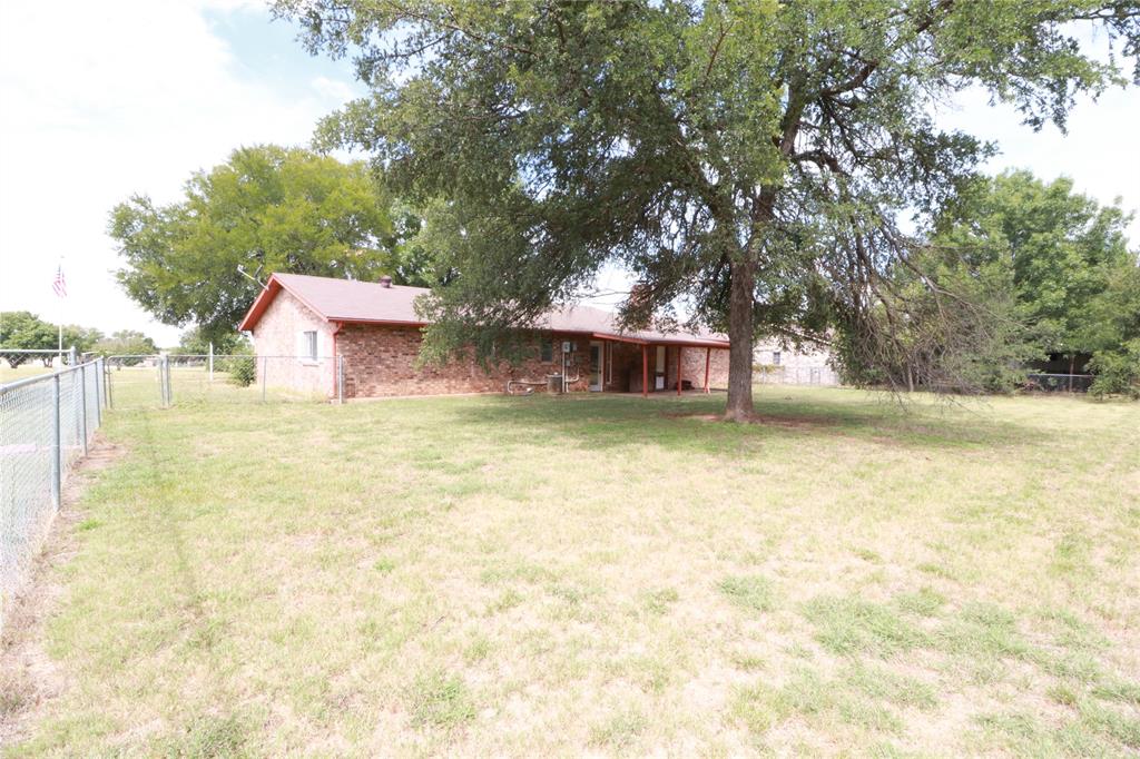 212 Palmer Drive Comanche, TX 76442 - Photo 34 of 40 a view of a house with pool and a bench
