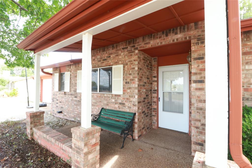 212 Palmer Drive Comanche, TX 76442 - Photo 36 of 40 a view of patio with a table and chairs and potted plants