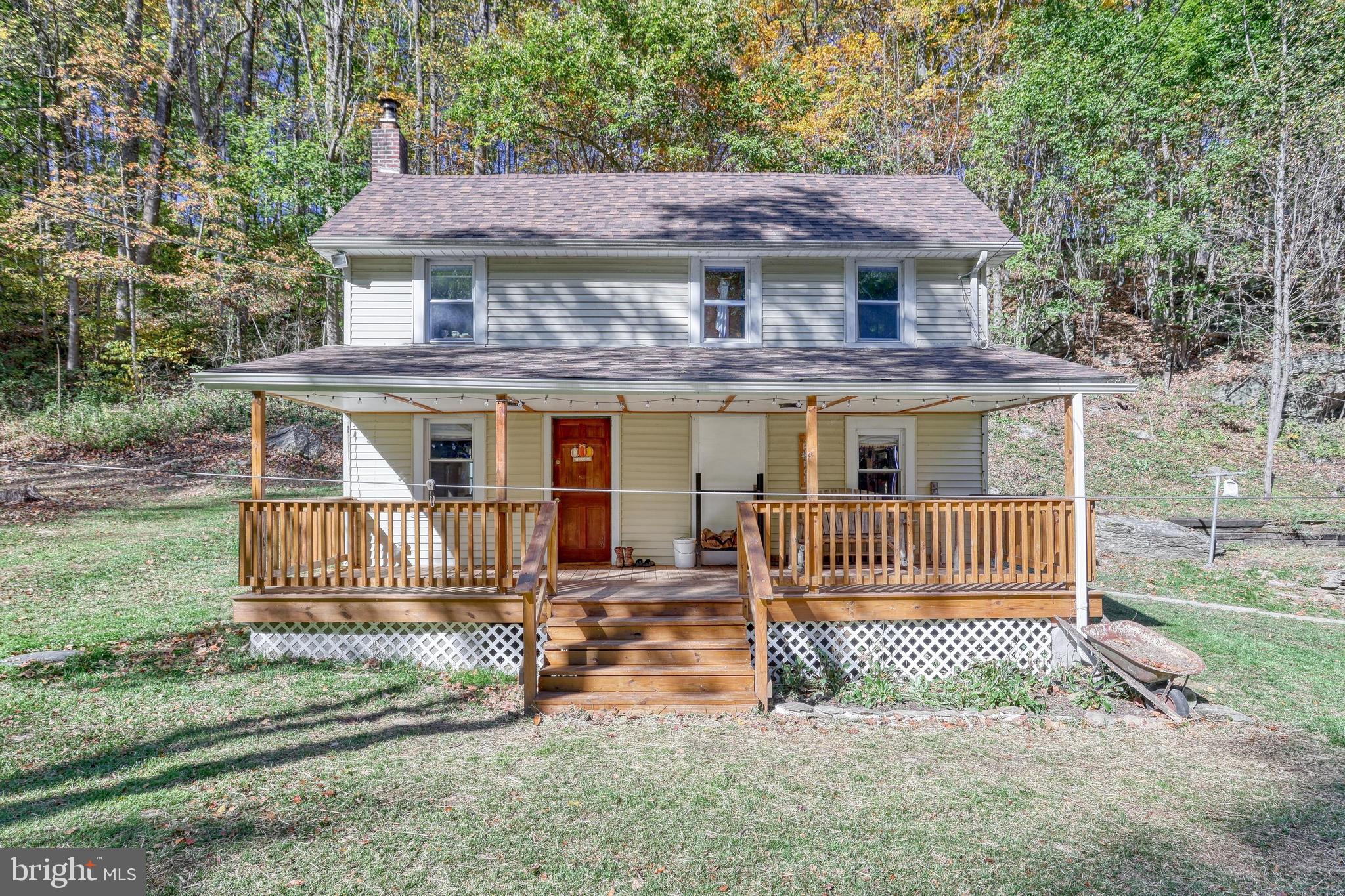 15120 Laurel Road Felton, PA 17322 - Photo 4 of 67 a front view of a house with a garden and fence