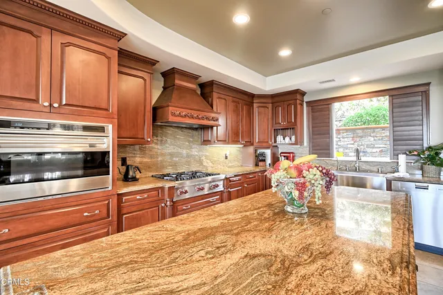 a dining room with furniture a wooden floor and kitchen view