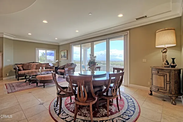 a living room with lots of furniture and kitchen view