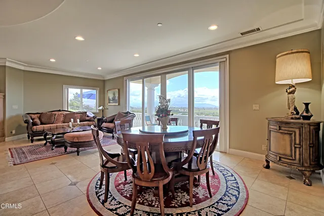 a living room with lots of furniture and kitchen view