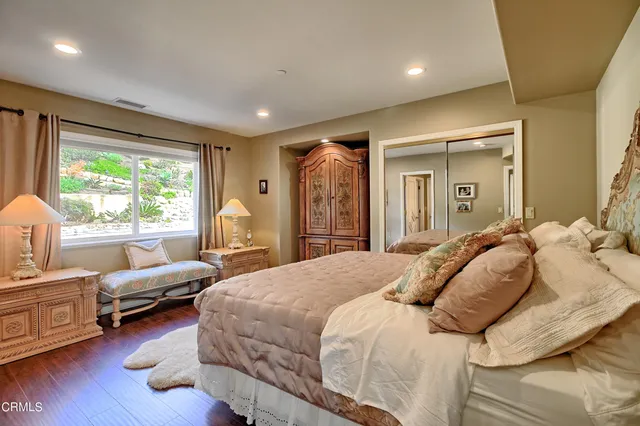a view of a bedroom with wooden floor