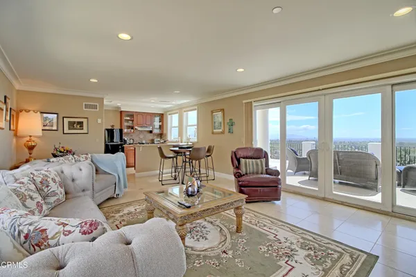 a living room with furniture a large window and a fireplace