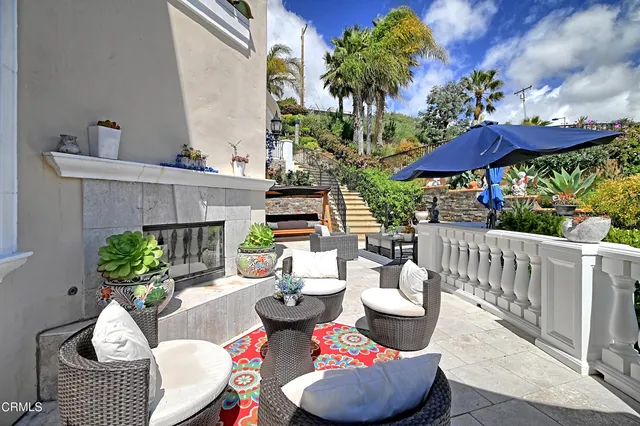 a view of a patio with couches and potted plants