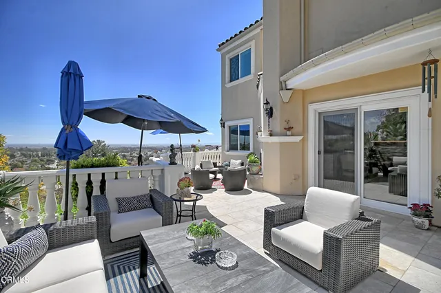 a view of a patio with couches and a fire pit