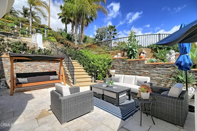 a view of a chair and tables in the balcony