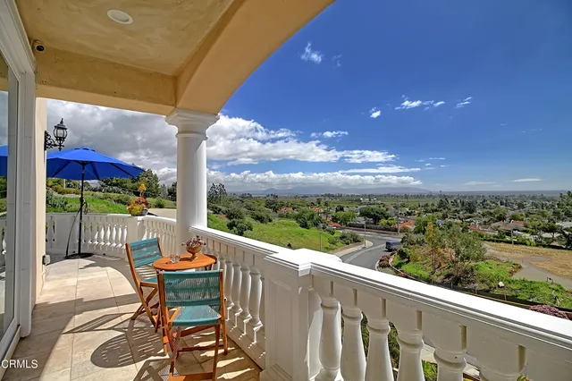 a view of a patio with table and chairs and potted plants