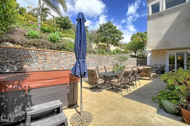 a view of a balcony with couches and wooden floor