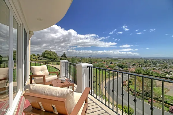 a view of a balcony with furniture