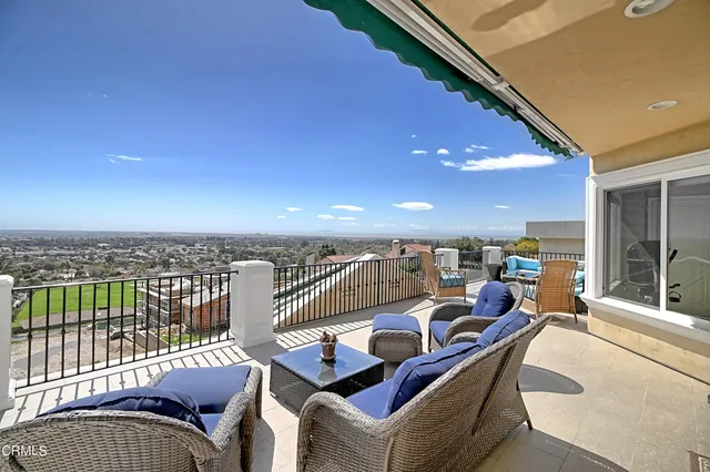 a view of balcony patio furniture and city view