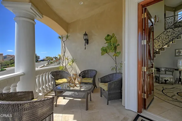 a balcony with furniture and a potted plant