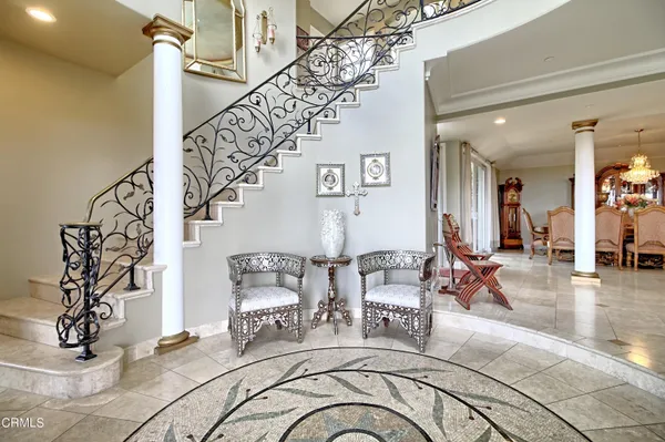 a view of a livingroom kitchen and dining room with chandelier