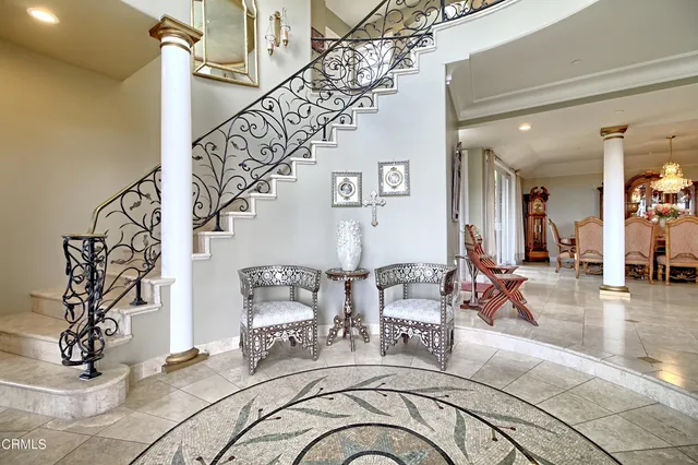 a view of a livingroom kitchen and dining room with chandelier