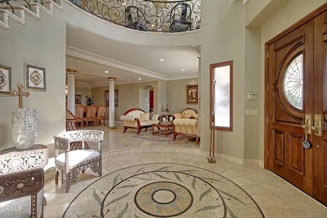 a view of a livingroom with furniture and mirror