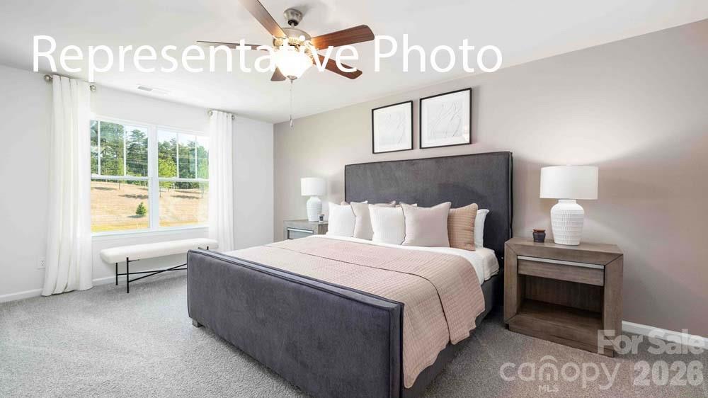 7592 Bainbridge Road Sherrills Ford, NC 28673 - Photo 12 of 28 a bedroom with a bed and a chandelier