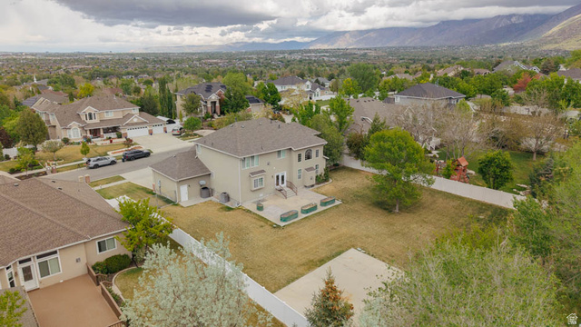 598 Hollow Creek Road Draper, UT 84020 - Photo 3 of 110 Expansive property featuring a multi-level home with a neutral stucco exterior, a large rear patio, and a spacious lawn area