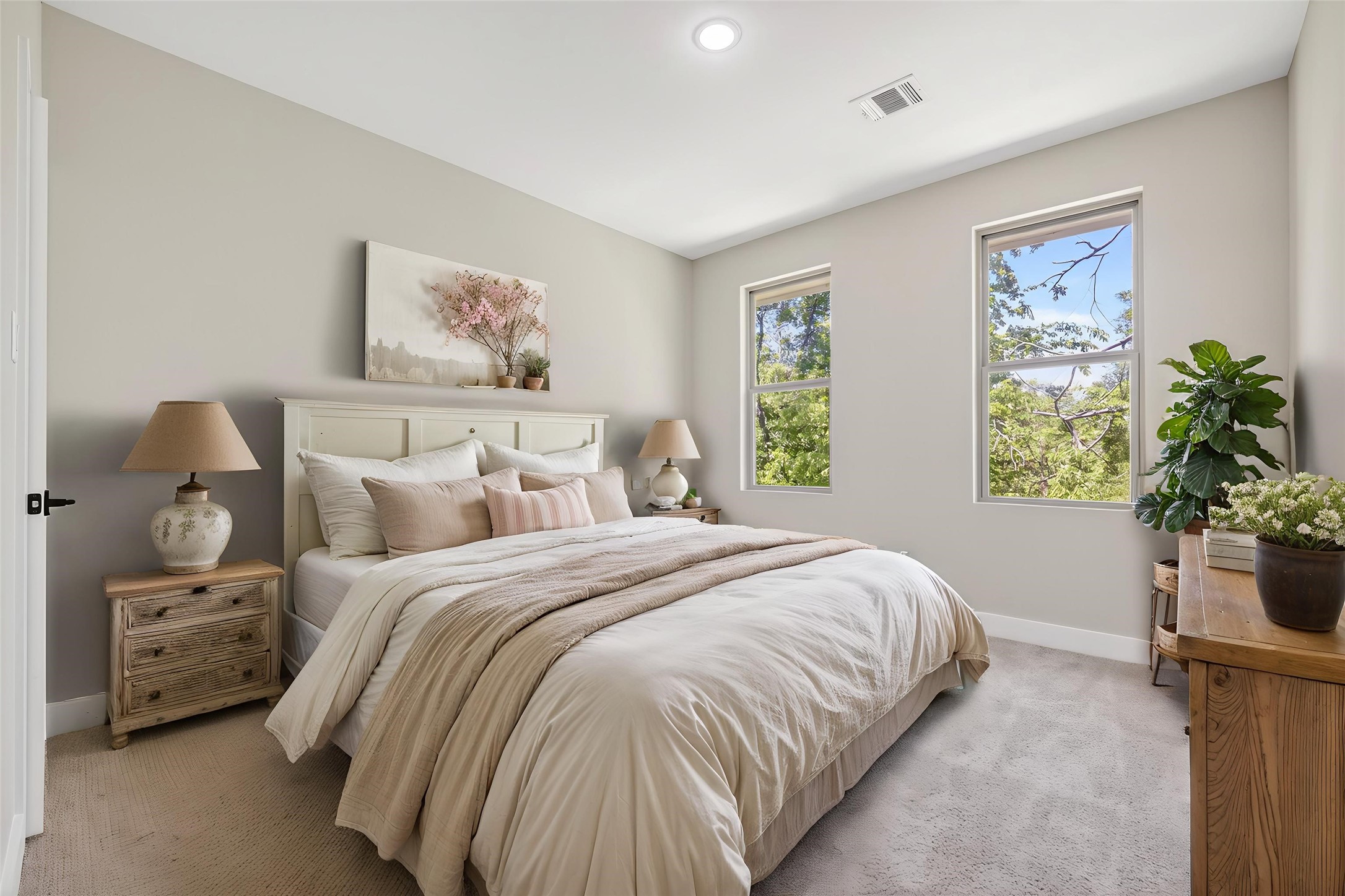 4930 Wunder Way Houston, TX 77069 - Photo 13 of 23 This AI-staged bedroom offers a serene retreat with soft neutral tones, cozy bedding, and abundant natural light from two windows overlooking lush greenery.